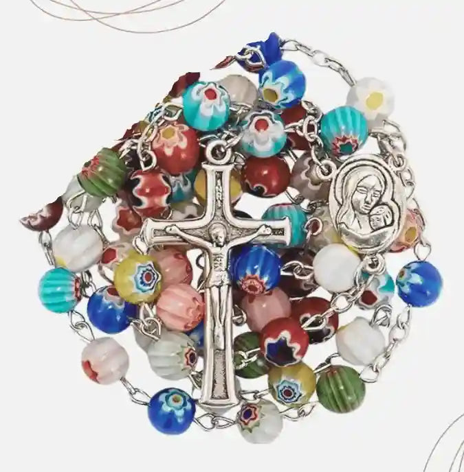Colorful rosary with multicolored beads and a cross on a white background