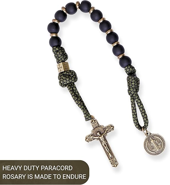Heavy-duty paracord rosary with dark beads and metal cross on a white background