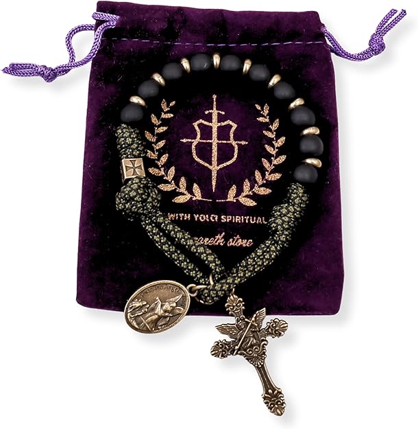 Black beaded one decade Rosary with gold accents and charms on a purple velvet bag
