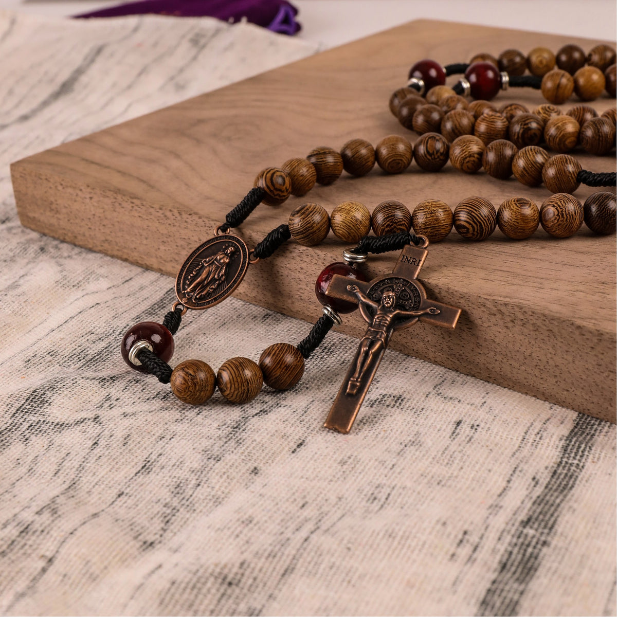 10mm olive wood beads and 12mm dark red wood mystery beads, this rosary offers a bold, strong design that’s perfect for men.