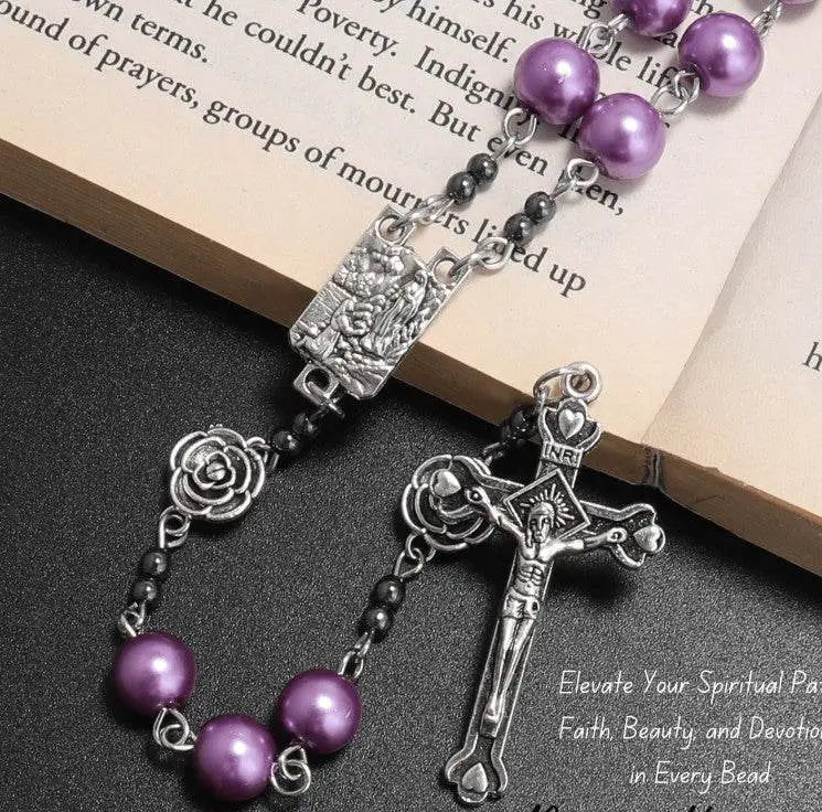 Rosary with purple beads and silver cross on an open book
