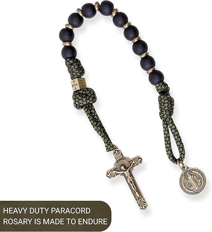 Heavy-duty paracord rosary with dark beads and metal cross on a white background
