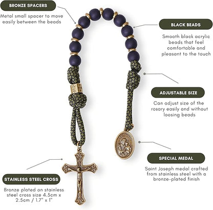 Rosary with black beads, bronze spacers, stainless steel cross, and Saint Joseph medal on a white background.