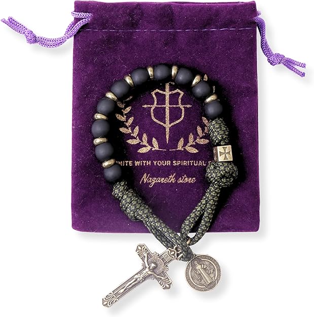 Black beaded one decade with silver cross and coin charm on a purple nazareth store bag.