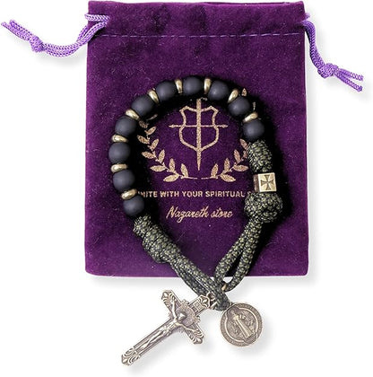 Black beaded one decade with silver cross and coin charm on a purple nazareth store bag.