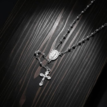 silver-plated rosary necklace featuring smooth 3 mm (0.12 inch) prayer beads, a finely detailed crucifix pendant measuring 1.3 cm (0.51 inch), and a classic Catholic design perfect for daily wear or devotional prayer.